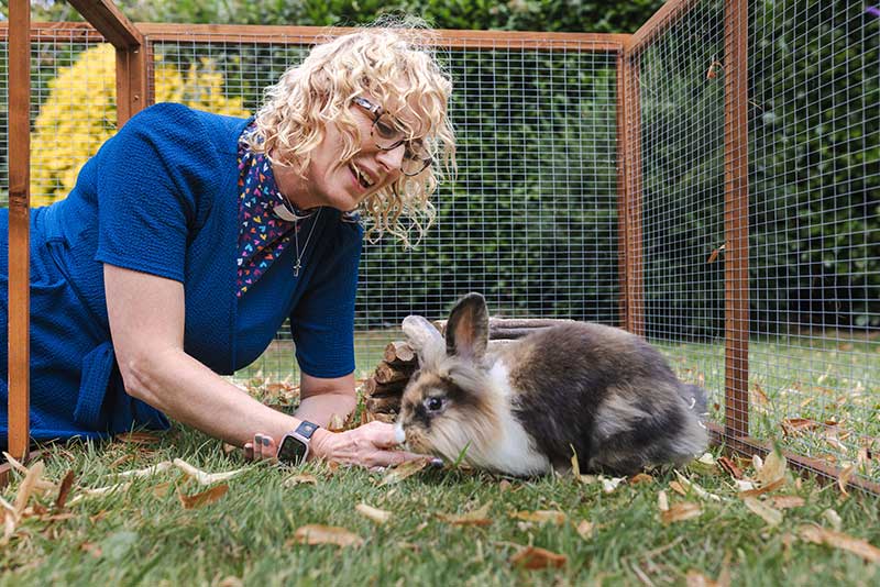 Reverend Liz Houghton caring for foster rabbits at her home in Newport through Blue Cross charity at Easter